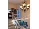 Bright staircase with carpeted steps leading to a large bookcase and a view of the outdoors at 4305 Sw 20Th Ave, Ocala, FL 34471