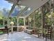Enclosed sunroom surrounded by walls of windows and skylights offering serene backyard views at 4305 Sw 20Th Ave, Ocala, FL 34471