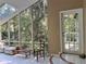 Sunroom with lots of natural light and views of the wooded landscape at 4305 Sw 20Th Ave, Ocala, FL 34471