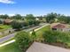 Aerial view of a well-maintained street with houses, green lawns, and mature trees at 4892 Nw 39Th Loop, Ocala, FL 34482