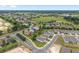 This aerial shot displays the neighborhood with its picturesque layout, highlighting the lush green spaces and neatly arranged residences at 4892 Nw 39Th Loop, Ocala, FL 34482