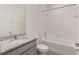 Bathroom featuring a vanity with granite countertop, toilet, and white tiled shower-tub combination at 4892 Nw 39Th Loop, Ocala, FL 34482