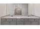 Modern bathroom with double sinks, granite counters, grey cabinets and glass enclosed shower at 4892 Nw 39Th Loop, Ocala, FL 34482