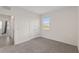 Well-lit bedroom featuring a window, carpet, and an entrance to a bathroom at 4892 Nw 39Th Loop, Ocala, FL 34482