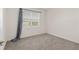 Bedroom with neutral carpeting, a window with blinds, and grey curtains at 4892 Nw 39Th Loop, Ocala, FL 34482