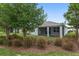 The exterior of the home features a screened-in lanai for relaxing, surrounded by lush green grass and mature trees at 4892 Nw 39Th Loop, Ocala, FL 34482