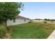 The exterior features a well-manicured lawn and landscaping, creating an inviting atmosphere for outdoor relaxation and enjoyment at 4892 Nw 39Th Loop, Ocala, FL 34482