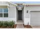 Home exterior featuring neutral siding, stone accents, and a welcoming front entrance at 4892 Nw 39Th Loop, Ocala, FL 34482