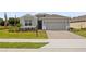 Charming single-story home featuring a neutral color palette, well-manicured lawn, and a brick-paved driveway at 4892 Nw 39Th Loop, Ocala, FL 34482