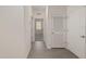 Bright hallway with tiled floors, white walls, and multiple doors leading to rooms at 4892 Nw 39Th Loop, Ocala, FL 34482
