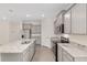 Open kitchen with stainless steel appliances, light gray cabinets, granite countertops, and tile flooring at 4892 Nw 39Th Loop, Ocala, FL 34482