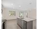 Open kitchen with granite island, stainless steel appliances, light gray cabinets and tile flooring at 4892 Nw 39Th Loop, Ocala, FL 34482