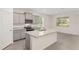 Kitchen featuring an island with a granite countertop and stainless steel sink, and light gray cabinets at 4892 Nw 39Th Loop, Ocala, FL 34482