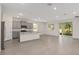 Open kitchen with gray cabinets, a granite island, and modern stainless-steel appliances at 4892 Nw 39Th Loop, Ocala, FL 34482