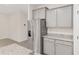 Spacious kitchen featuring stainless steel refrigerator, granite countertops, and light gray cabinets at 4892 Nw 39Th Loop, Ocala, FL 34482