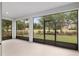 Enclosed lanai with views of the lush green yard and surrounding trees at 4892 Nw 39Th Loop, Ocala, FL 34482