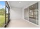The screened lanai features a sliding glass door and a view of the yard at 4892 Nw 39Th Loop, Ocala, FL 34482