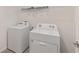 Laundry room featuring a white washer and dryer with white wire shelving above at 4892 Nw 39Th Loop, Ocala, FL 34482