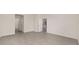 Neutral living room featuring tile floors and doors leading to other rooms at 4892 Nw 39Th Loop, Ocala, FL 34482