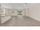 Bright, open-concept living room with tiled floors and a sliding door leading to the backyard at 4892 Nw 39Th Loop, Ocala, FL 34482