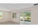 Living room featuring tile floors, recessed lighting, and sliding glass doors leading to screened patio at 4892 Nw 39Th Loop, Ocala, FL 34482