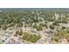 Expansive aerial view of a charming residential neighborhood surrounded by lush greenery and mature trees at 5425 Pecan Rd, Ocala, FL 34472