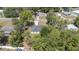 Home aerial showcases the roof, surrounded by mature trees and landscaping at 5425 Pecan Rd, Ocala, FL 34472