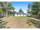 Expansive backyard with lush green grass and mature trees, offering privacy and plenty of room to enjoy at 5425 Pecan Rd, Ocala, FL 34472