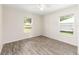 Bedroom with wood-look flooring, and natural light through windows, offering a comfortable and inviting atmosphere at 5425 Pecan Rd, Ocala, FL 34472