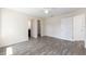 Spacious bedroom featuring wood-look floors, access to en-suite bathroom and closet, offering comfort and convenience at 5425 Pecan Rd, Ocala, FL 34472