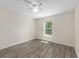 Well-lit bedroom with hardwood floors, with a window to the backyard at 5425 Pecan Rd, Ocala, FL 34472