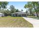 Charming single-story home with an expansive front lawn, long driveway, and attached two-car garage at 5425 Pecan Rd, Ocala, FL 34472