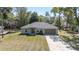 Charming single Gathering home with a 2-car garage and mature landscaping at 5425 Pecan Rd, Ocala, FL 34472