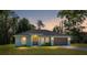 Inviting single-story home featuring a well-manicured lawn, a two-car garage, and a charming front entrance at 5425 Pecan Rd, Ocala, FL 34472