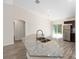 Open kitchen with granite island, stainless steel appliances, and sliding glass doors to the outdoor space at 5425 Pecan Rd, Ocala, FL 34472