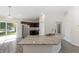Bright kitchen featuring stainless steel appliances, dark cabinets, granite countertops, and wood-look flooring at 5425 Pecan Rd, Ocala, FL 34472