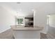 Kitchen showcasing a granite countertop island with a double sink, stainless steel fridge, and modern lighting at 5425 Pecan Rd, Ocala, FL 34472