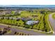 Overhead view of community amenities including pool, tennis courts, bocce ball and a clubhouse surrounded by lawns at 6265 Sw 88Th Loop, Ocala, FL 34476