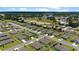 Expansive aerial view captures a neighborhood with neatly arranged homes, green spaces, and recreational fields at 6265 Sw 88Th Loop, Ocala, FL 34476