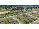 An aerial view highlights a well-planned community with uniform homes, manicured lawns, and mature trees at 6265 Sw 88Th Loop, Ocala, FL 34476