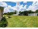 Green backyard with white vinyl fence offering privacy and space for outdoor activities at 6265 Sw 88Th Loop, Ocala, FL 34476
