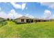 Large backyard with well-maintained lawn and a view of neighboring properties at 6265 Sw 88Th Loop, Ocala, FL 34476