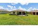 Expansive backyard featuring a screened lanai and lush green grass at 6265 Sw 88Th Loop, Ocala, FL 34476