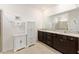 Modern bathroom with double vanity, granite counters, stylish cabinets, and tiled floor at 6265 Sw 88Th Loop, Ocala, FL 34476