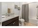 Bathroom featuring granite countertops, a vanity with dark cabinets, and a shower with a curtain at 6265 Sw 88Th Loop, Ocala, FL 34476