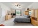 Bright bedroom with neutral carpet, light wood furnishings and a large window with natural light at 6265 Sw 88Th Loop, Ocala, FL 34476