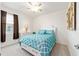 Bedroom with a patterned blue comforter and a window dressed with dark curtains at 6265 Sw 88Th Loop, Ocala, FL 34476