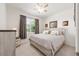 Bedroom with neutral tones, plush carpeting, and a large window letting in natural light at 6265 Sw 88Th Loop, Ocala, FL 34476
