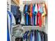 Well-organized closet with clothes hanging and folded on shelving and multiple racks at 6265 Sw 88Th Loop, Ocala, FL 34476