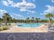 Community pool surrounded by palm trees, lounge chairs, and cabanas, set in a scenic landscaped area at 6265 Sw 88Th Loop, Ocala, FL 34476